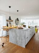 A modern kitchen island with a seating place and bar stools