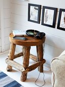Hand-crafted, wooden stool used as side table