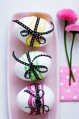 White eggs tied with ribbons