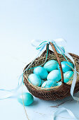 A basket of turquoise Easter eggs
