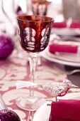 A red wine glass on table decorated for Christmas