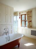 Free standing bathtub with a vintage look in a white, traditional bathroom