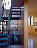 Open staircase and view through a hallway into a kitchen