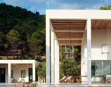 Contemporary villa with colonnade and free standing extension in a Mediterranean landscape