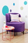 A purple Lounge chair with a velvet cover next to a Moroso table