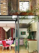 House with brick facade and view into dining area through open, modern terrace doors
