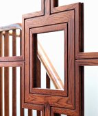 Beautifully crafted wooden frame of mirrored sliding door with reflection of staircase balustrade