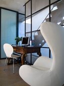 White Bauhaus armchair and antique desk in contemporary house