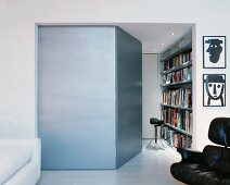 Side room of modern living room with open door and view of bookcase