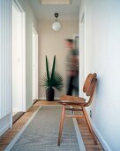 Hallway with 50s chair and runner