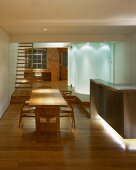 Open-plan living space with dining area and backlit, cylindrical glass installations