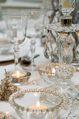 Tealights in glass dishes and candlestick decorated with glass ornaments