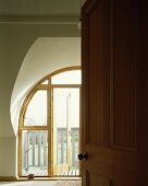 View of wooden balcony door through open door