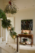 Christmas decorations on stairs in foyer of country house