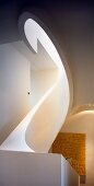 Sculptural element - oval spiral staircase with solid balustrade and view of modern artwork with text motif