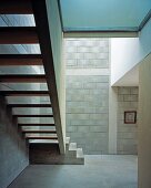 Simple stairwell with concrete staircase and brick walls