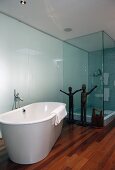 Bathroom with free-standing bathtub, shower & scupltures