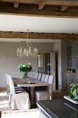 Festive dining table and loose-covered chairs in renovated country house