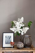 Arrangement of white lilac, old candle lanterns and modern black and white photo