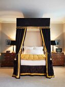 Elegant four-poster bed with black velvet canopy