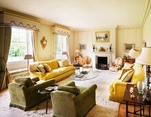 Colourful, upholstered seating in traditional living room with fireplace