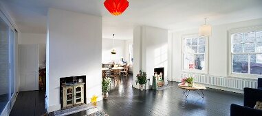 Wall elements with converted fireplaces in open-plan, sunny living space in an old building in London