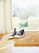 Baseball boots on doormat