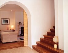 Modernised foyer with open sliding door and view into living room through rounded arched doorway