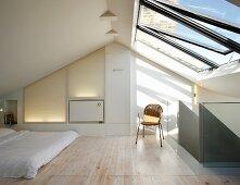 Minimalist bedroom beneath half-glazed roof