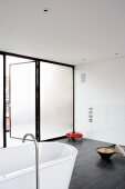 Designer bathroom with open terrace door