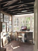 Narrow room with desk in bay window