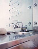 Stainless steel washstand and designer tap fittings on mirror