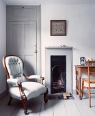 Antique armchair next to open fireplace