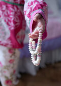 A girl holding a candy necklace