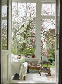 View into conservatory of country house through open door