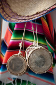 Small drums and ethnic blanket hanging on wall