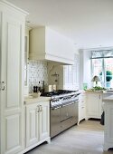 Country house kitchen with large stainless steel gas cooker