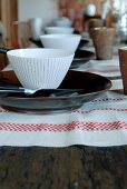 Festive table set with linen table mats, plates and bowls