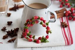 Jug of chai tea and small wreath of St. John's wort berries