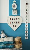 Arrangement of baby photos on wall in child's bedroom with blue and white walls