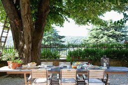 Breakfast on Mediterranean terrace and view of trees and landscape