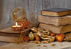Gold Christmas decorations and a stack of books