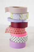 A stack of various rolls of masking tape