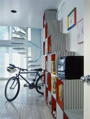 Boy's room with cubic shelving, bike and spiral staircase