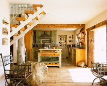 Rustic kitchen in open-plan interior with staircase