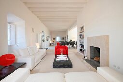 Modern white living room with red chair