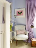 Antique armchair and modern standard lamp in corner of lilac room next to floor-length curtain at window