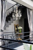 Silver curtains with glass chandelier in Moroccan courtyard home