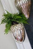 Christmas decoration of silver acorns with cypress sprigs