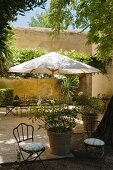 Parasol and seating area in grounds of Provence country house